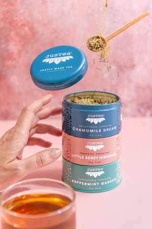 Justea Herbal Tea Trio with hand and spoon
