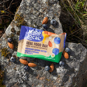 Made with Local blueberry almond butter bar on rock with almonds and blueberries
