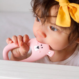 Pink bear silicone teether Little Cheeks in baby's mouth