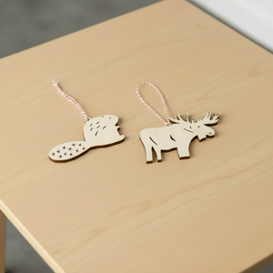 Light + Paper Beaver and Moose Ornaments on table