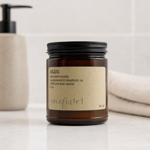 Soy candle labeled 'calm' in bathroom