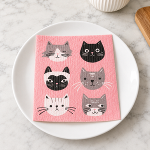 Cats Meow Swedish dishcloth on white plate on counter