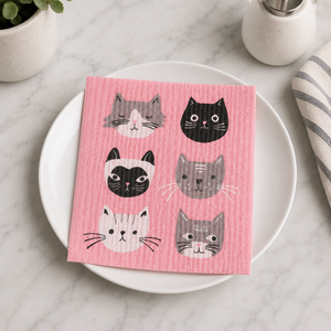 Cats Meow Swedish dishcloth on white plate on counter beside plant and soap
