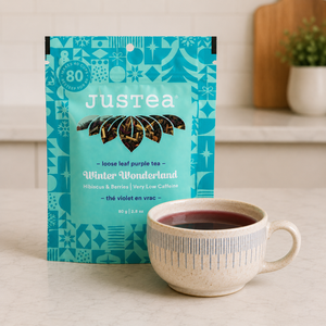 Justea Winter Wonderland loose leaf purple tea on kitchen island with teacup