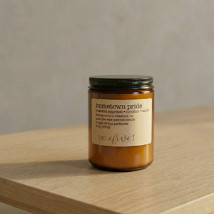 Hometown pride soy candle onefive1 on table