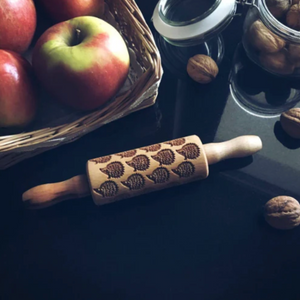 Goody Woody hedgehog rolling pin beside apples