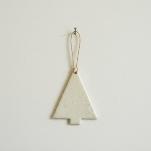 Minimalist Christmas tree ornament hanging on wall