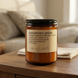 Hometown pride soy candle onefive1 on bedside table