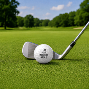 "I like golf more than people" ball beside club on golf course