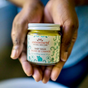 Anointment Baby Balm in person's hands