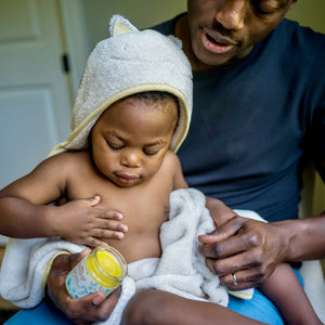 Anointment Baby Balm being applied on baby by adult