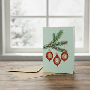 Joy Christmas Card in front of snowy window
