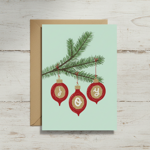 Joy Christmas Card on white wood table