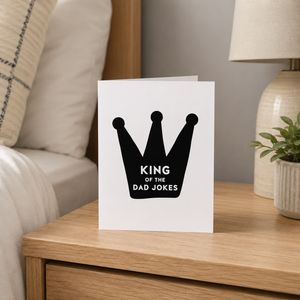 King of the Dad Jokes card Pretty by Her on nightstand