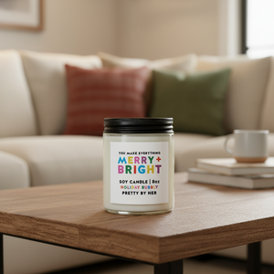 Merry and Bright soy candle Pretty by Her on coffee table