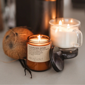 Hometown pride soy candle onefive1 with coconut and white candle in background