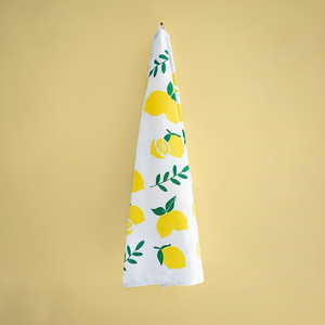 Plantish lemon tea towel hanging against yellow background