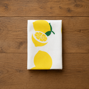Plantish lemon tea towel folded on kitchen table