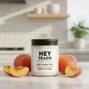 Hey Teach Candle Pretty by Her on counter with peaches