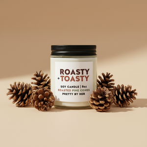 Roasty Toasty candle pretty by her with pinecones