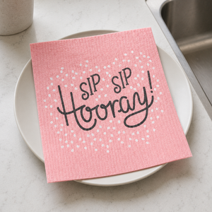 Sip Sip Hooray Swedish Dishcloth on plate on counter