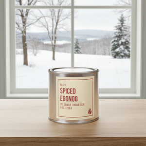 Spiced eggnog soy candle paint can in front of window