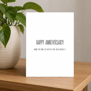 Stevie and Bean Happy Anniversary card on small table beside plant