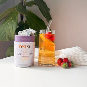 Tease Self Care Elixir beside glass