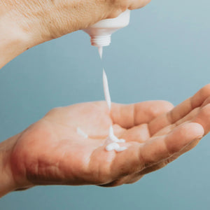 Nova Scotia Fisherman Hand and Body Lotion beside squeezed onto man's hand