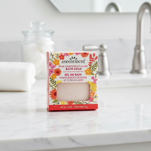 Anointment pink grapefruit and lime bath soak on bathroom counter