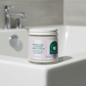 warm chai and ginger body scrub Midnight Paloma on edge of bathtub