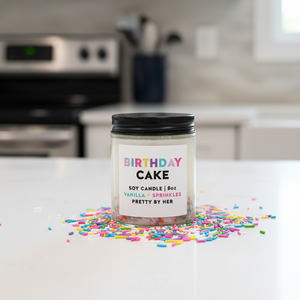 Birthday Cake Candle Pretty by Her on kitchen counter surrounded by sprinkles