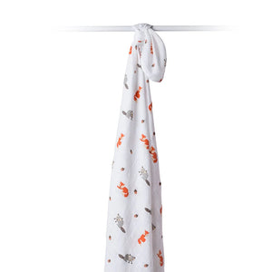 Lulujo Forest Friends Swaddle Blanket hanging from bar