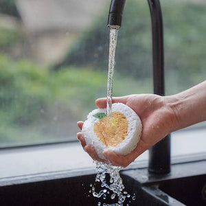 Orange Pop-Up Sponge by Plantish getting rinsed
