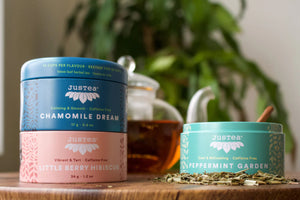 Justea Herbal Tea Trio in front of teapot and plant