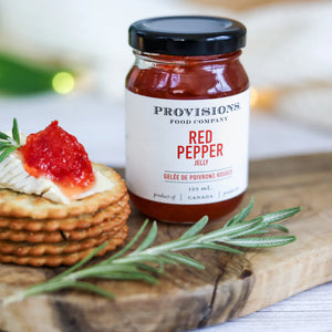 Provisions Red Pepper Jelly beside a stack of crackers
