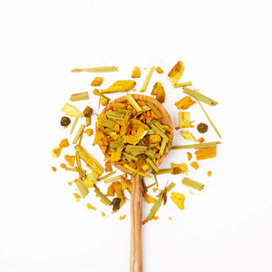 Justea Turmeric Ginger tea in wooden spoon