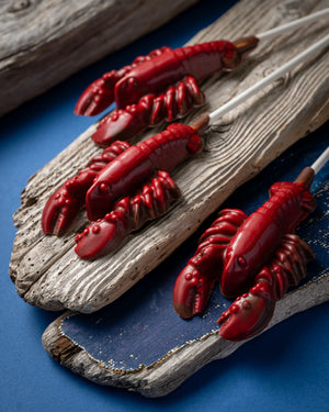 Rousseau chocolate red lobster lollies on wood planks