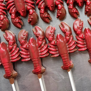 Rousseau chocolate red lobster lollies in a line